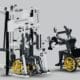Adaptive gym equipment designed for individuals in wheelchairs, featuring modified exercise machines and a wheelchair user actively engaging in fitness.